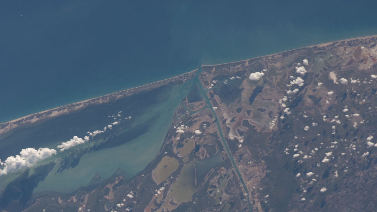 South Padre Island, Port Isabel and the Brownsville Ship Channel seen from the International Space Station, with the Gulf at the top