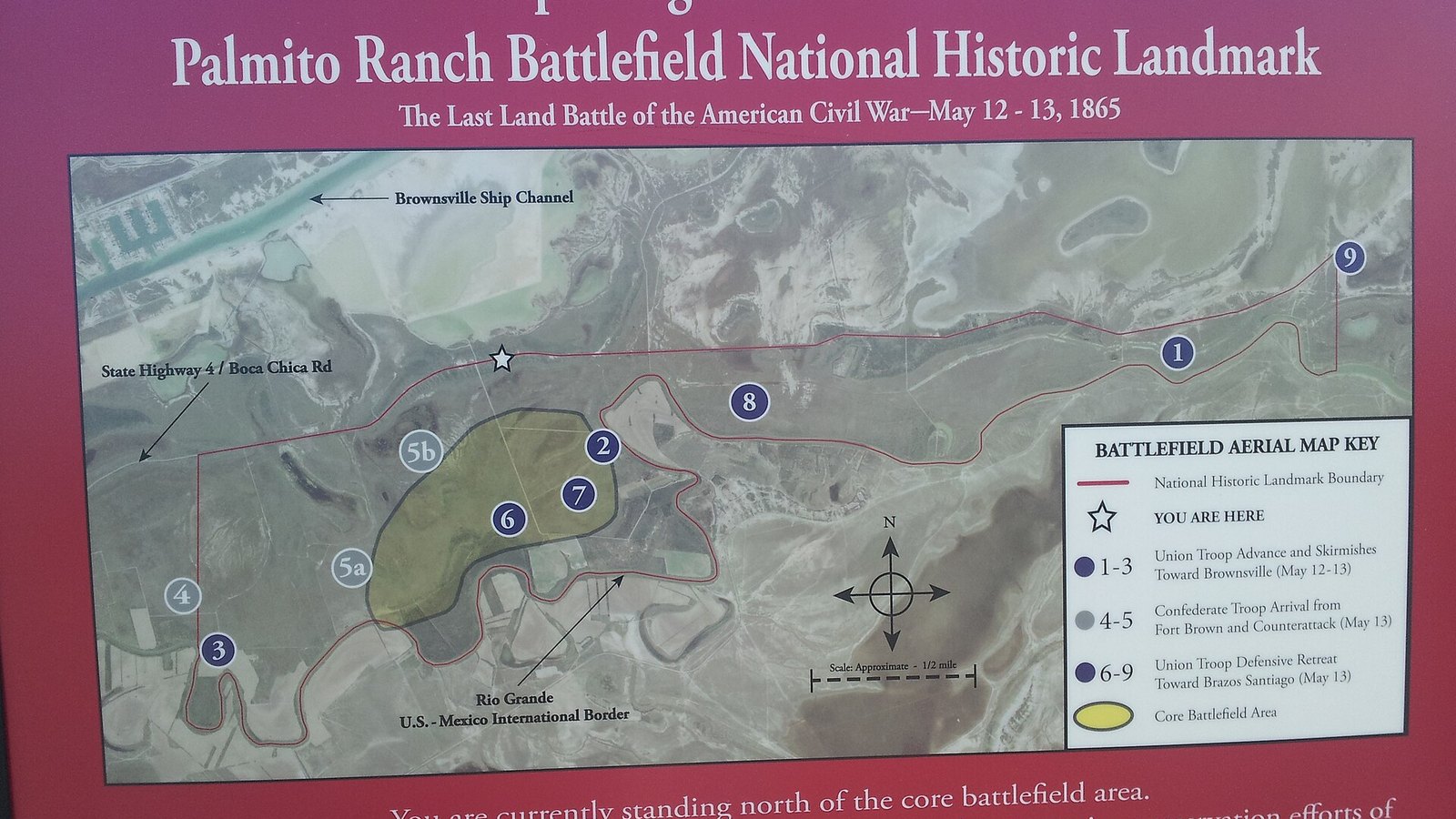 A red roadside sign for the Palmito Ranch Battlefield National Historic Landmark, the last land battle of the American Civil War, May 12 to 13, 1865, with an aerial map of the battlefield between State Highway 4 and the Rio Grande